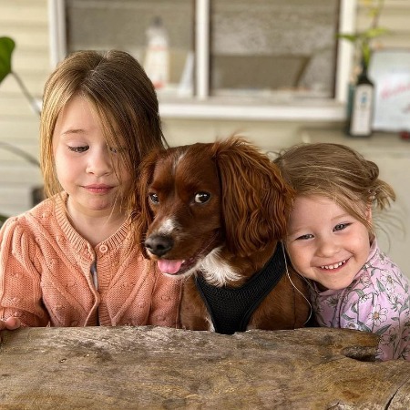 Mercy Weir and her little sister with their dog.